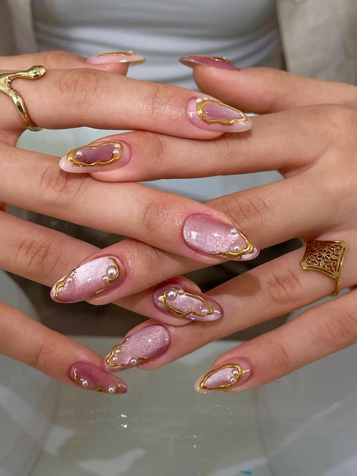 Mauve shimmer with gold-framed aura shapes and pearls