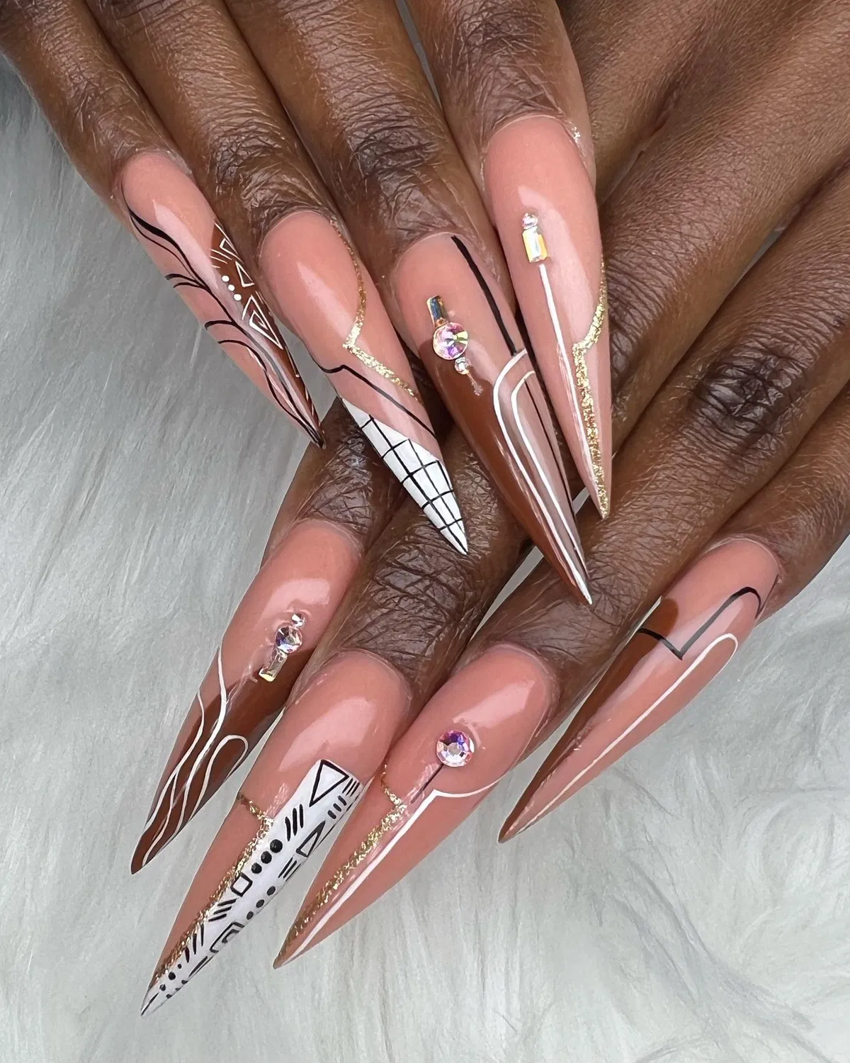 Extra-long stiletto set with graphic lines, gold glitter, and rhinestones