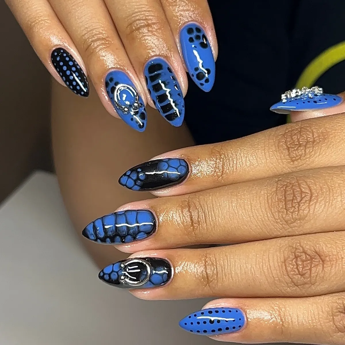 Blue-and-black dots, stripes, and metallic charms