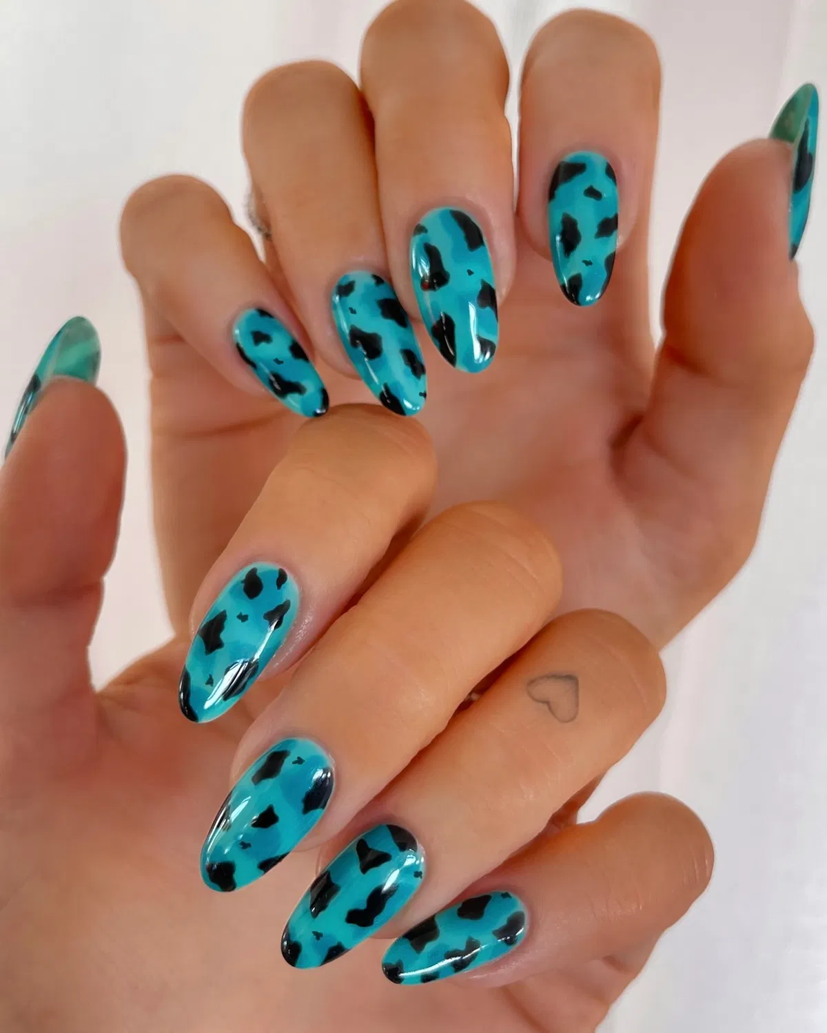 Turquoise nails with irregular black spots