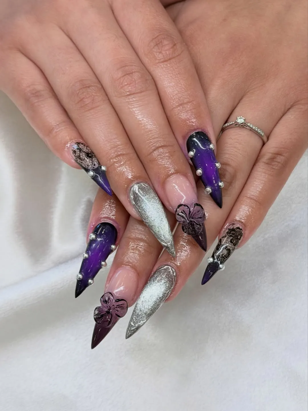 Full set: purple-black gradients, silver chrome-look nails, and 3D flowers