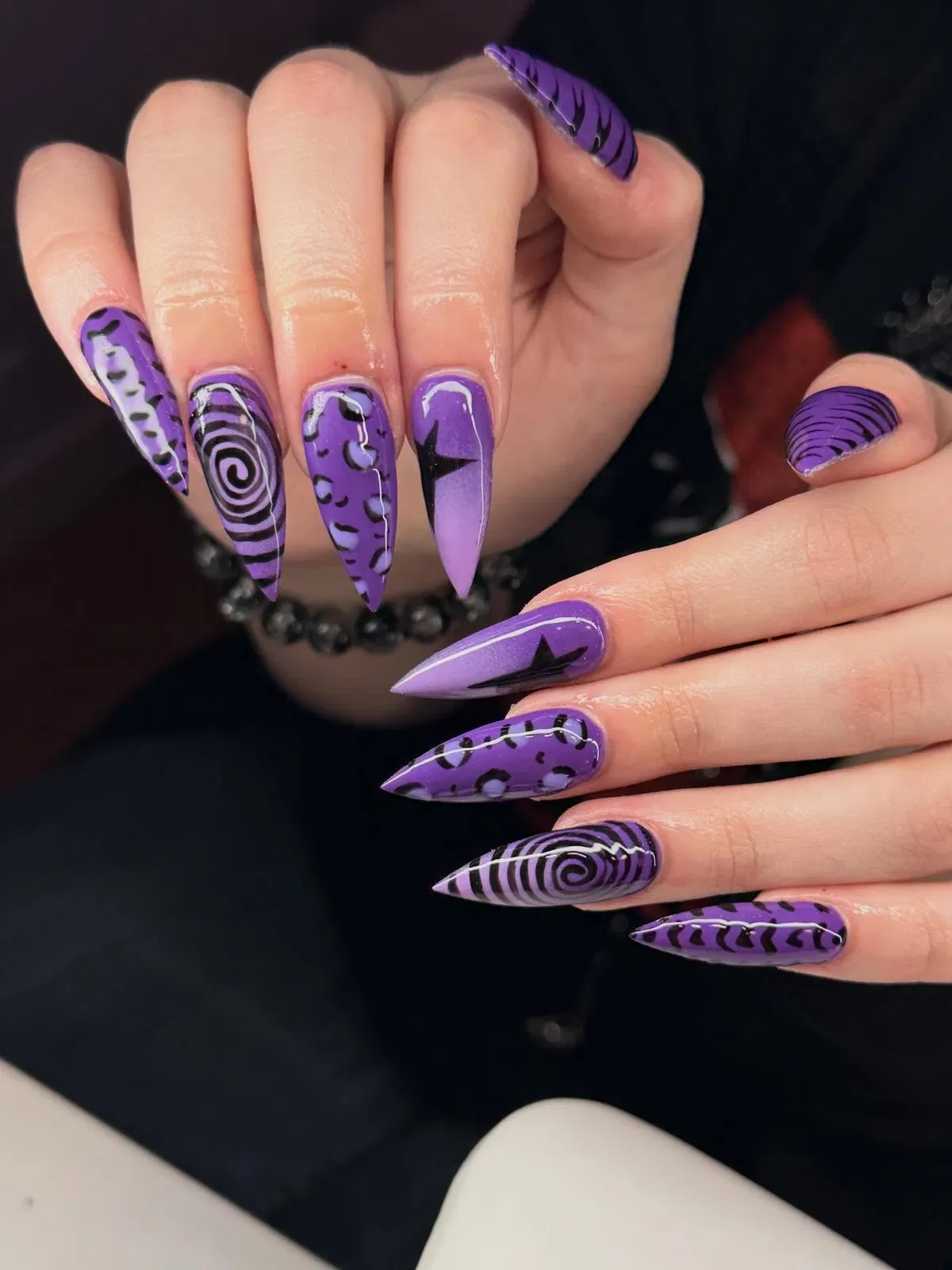 Purple graphic mix: spirals, spots, and star accents