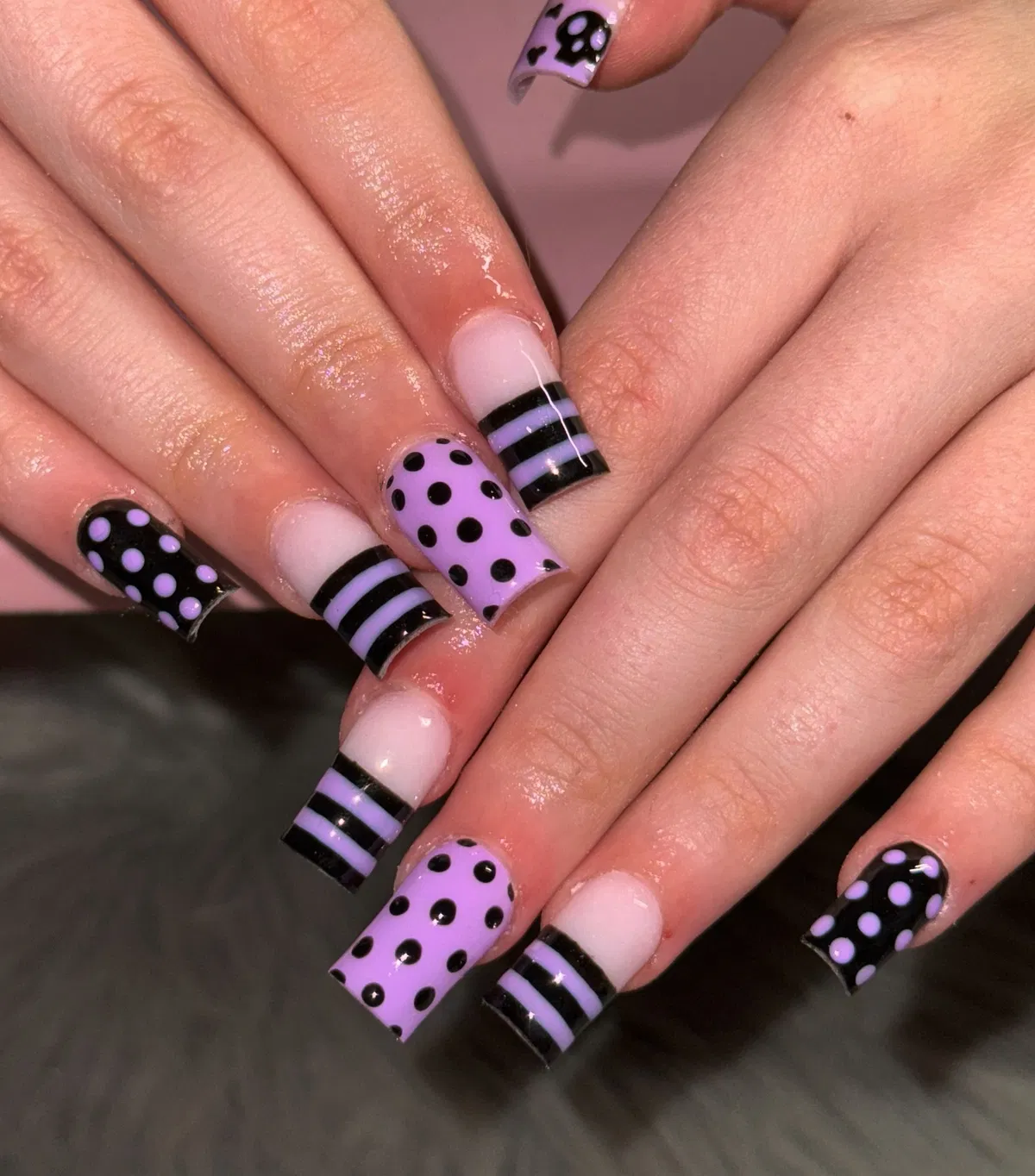 Polka dots and striped bands in black and lavender
