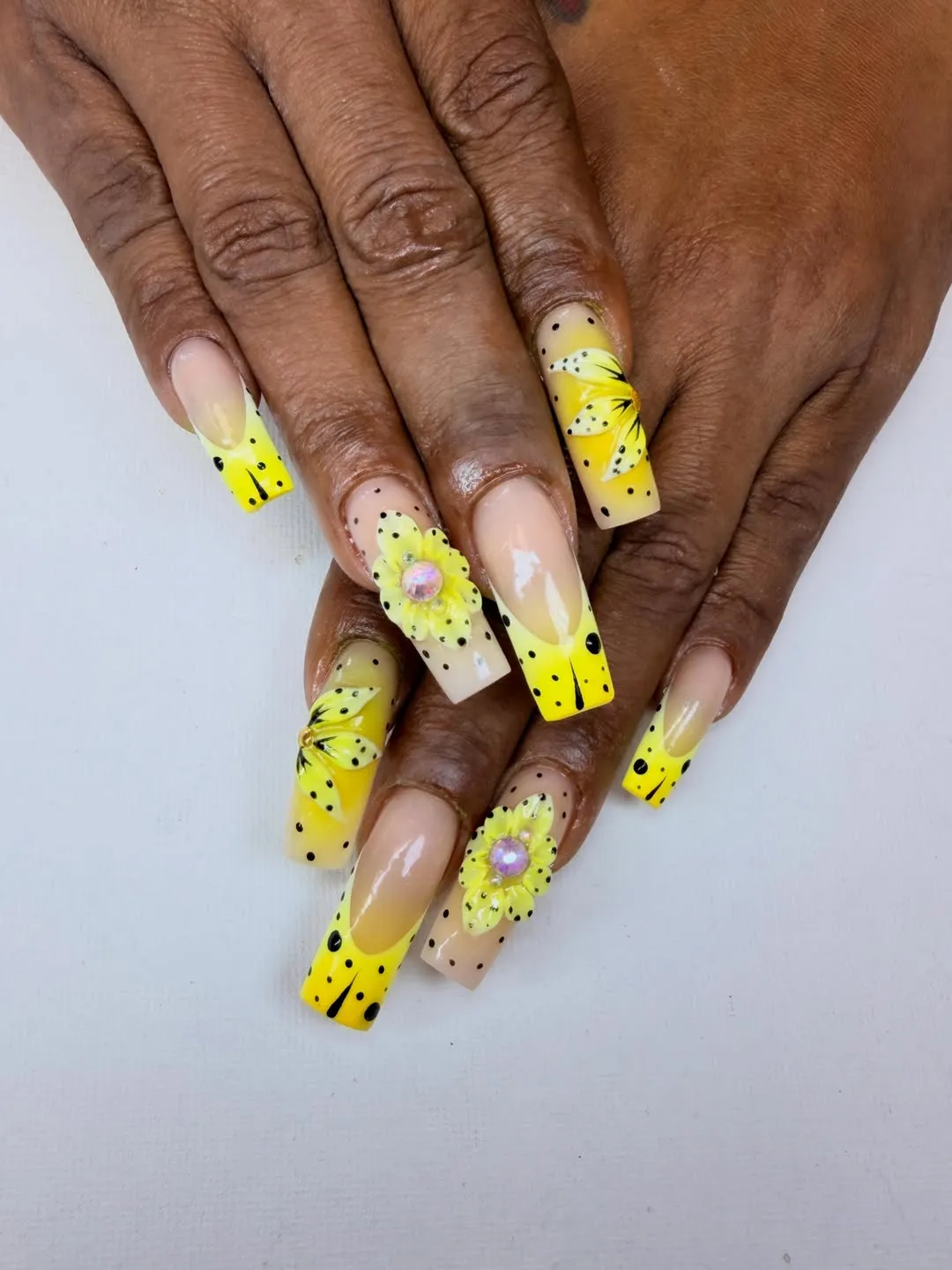 Nude-to-yellow ombré with black speckles and 3D yellow flowers