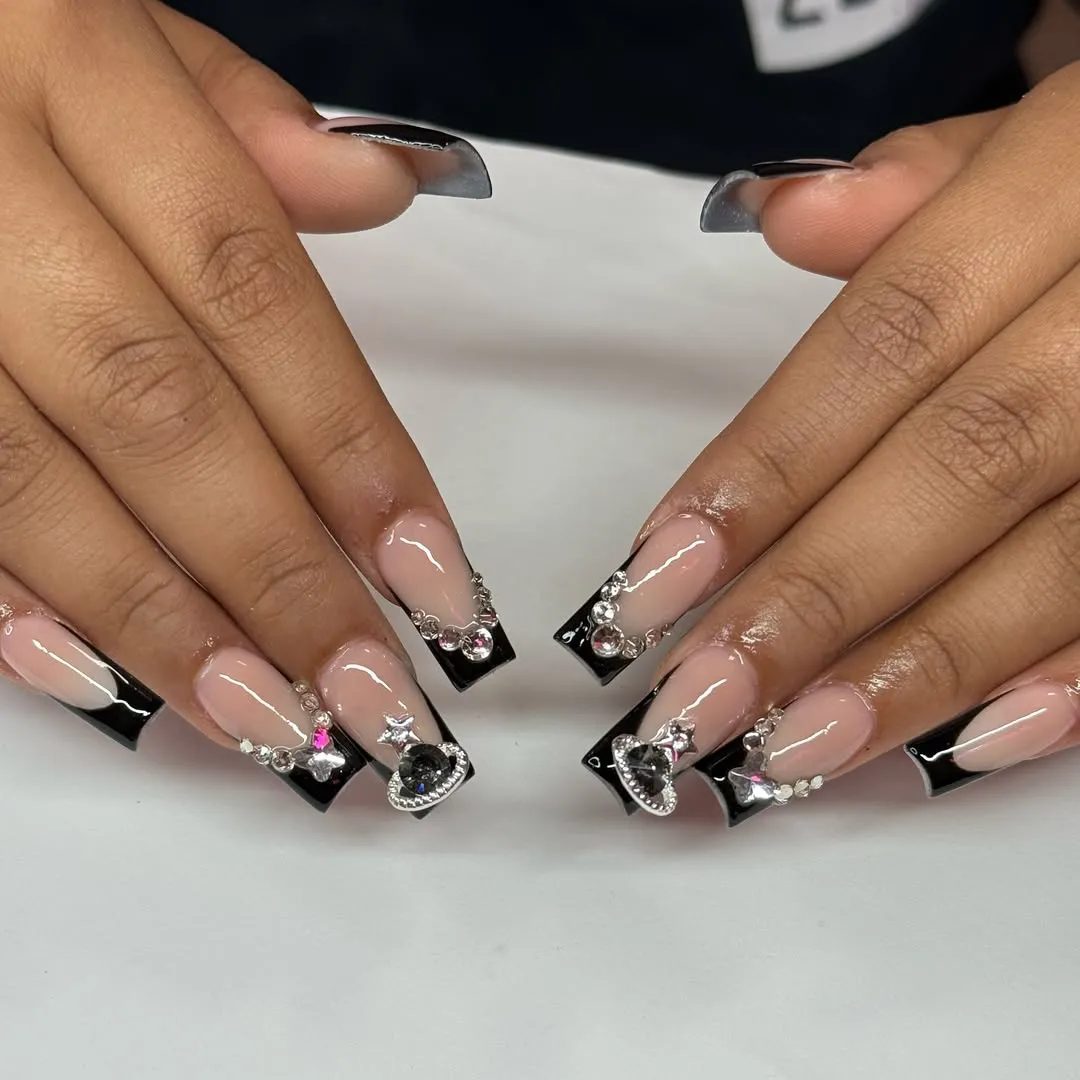 Nude-to-dark gradient tips with cross charms and studded embellishments