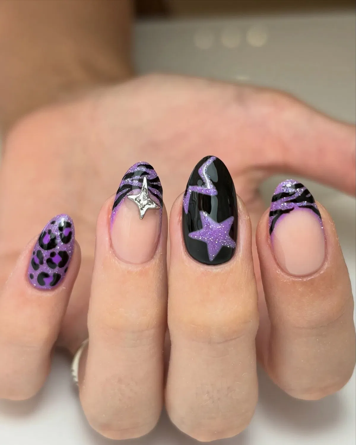 Purple glitter star and striped accents on black and nude