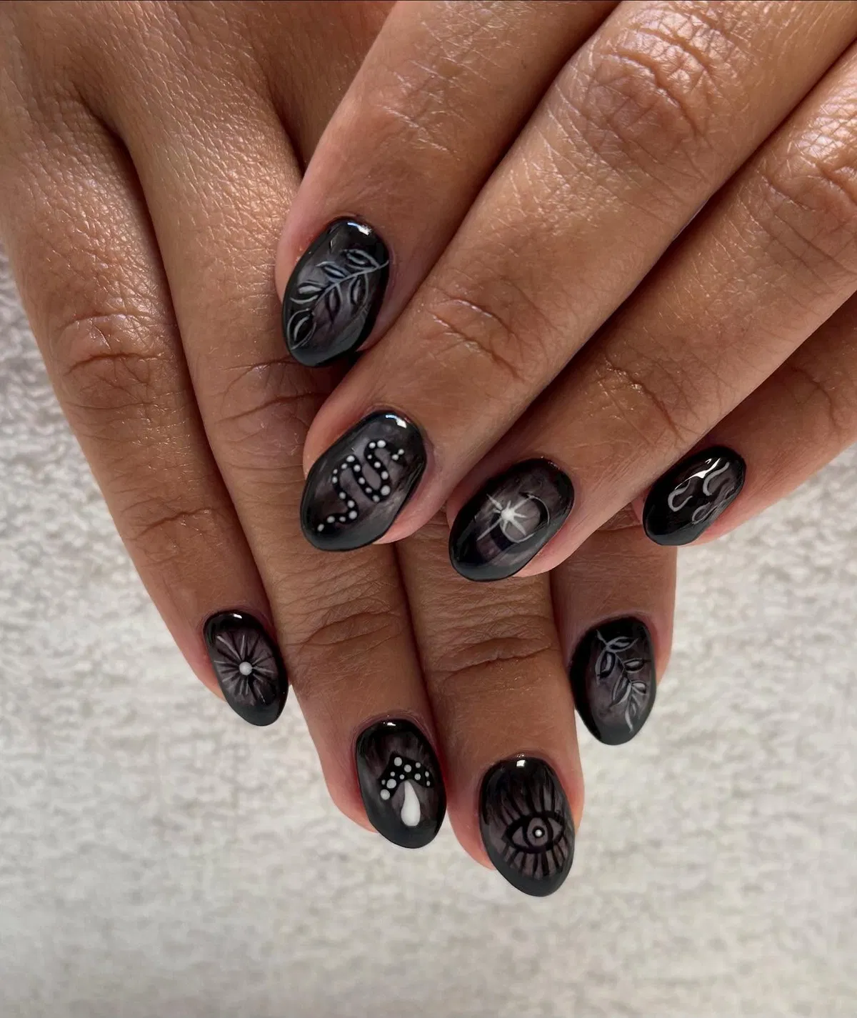 Dark ombre base with monochrome illustrated motifs