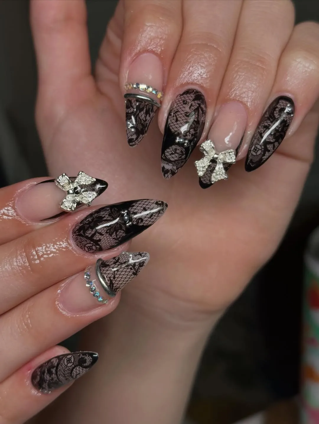 Nude-and-black lace pattern with silver bow embellishments