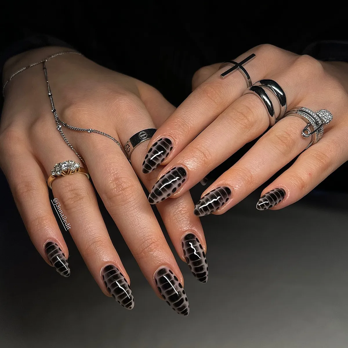 Gray-and-black animal-print pattern across glossy almond nails