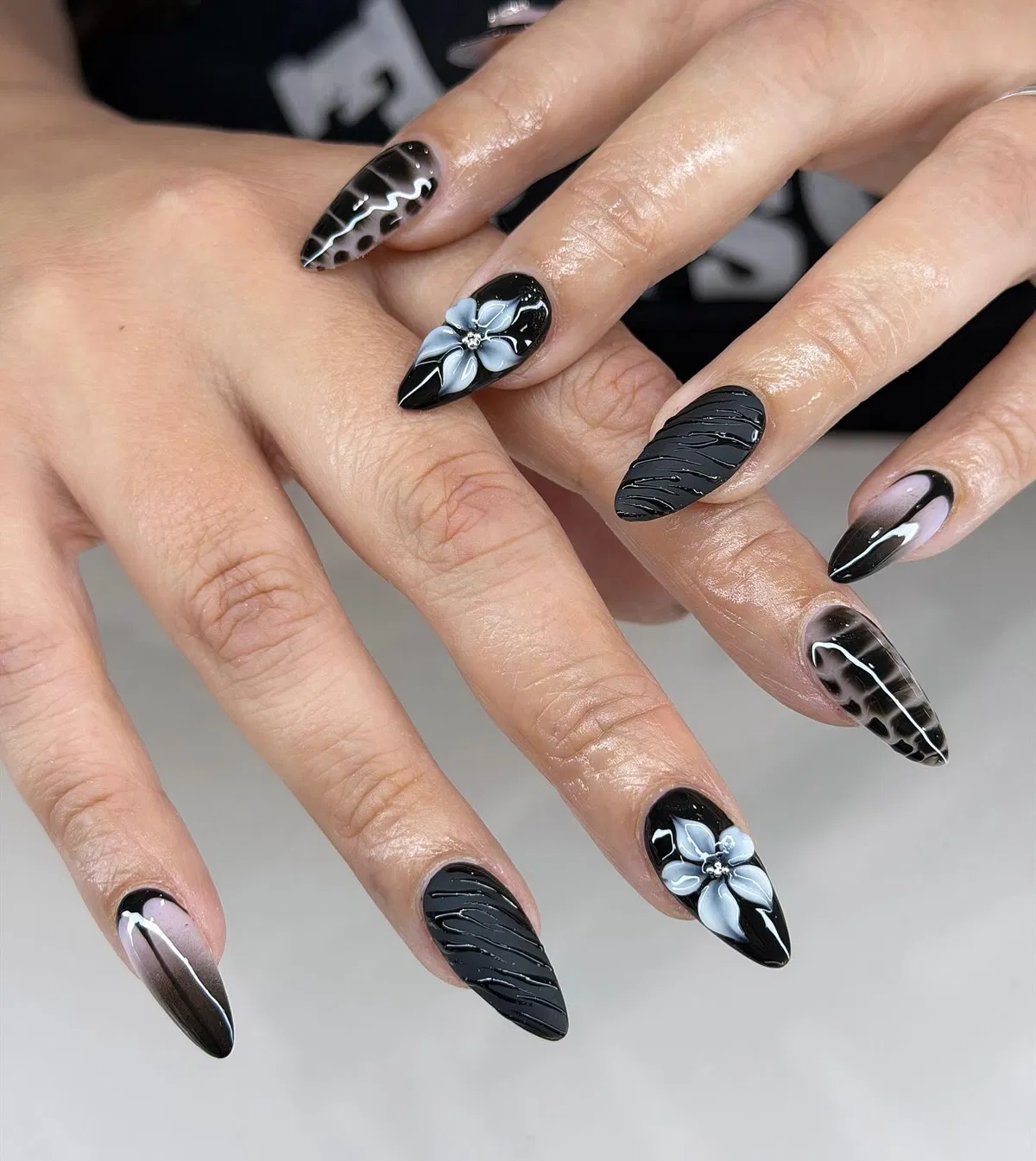 Glossy black mix: 3D flowers, textured lines, and animal-print accents