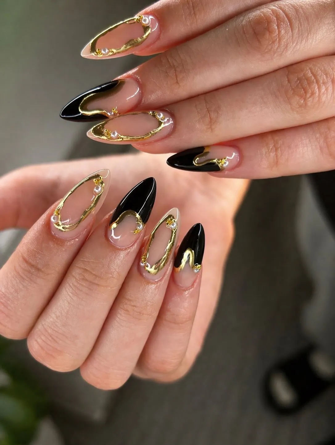 Nude and black tips with outlined loops and pearl-like accents