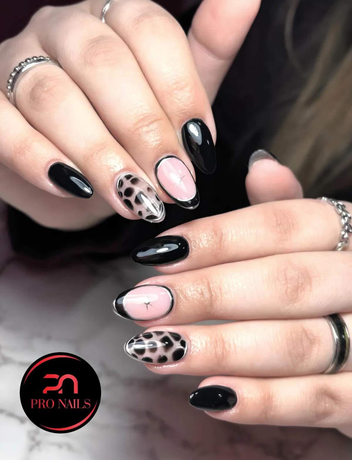 Glossy black solids with framed nude accents and animal-print pattern