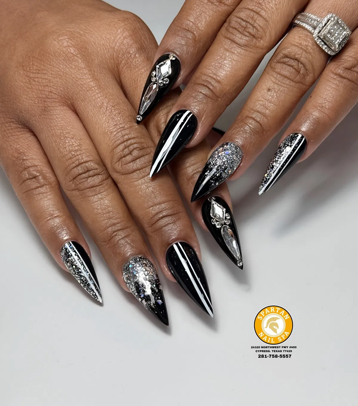 Black stilettos with white striping, silver glitter, and large crystal accents