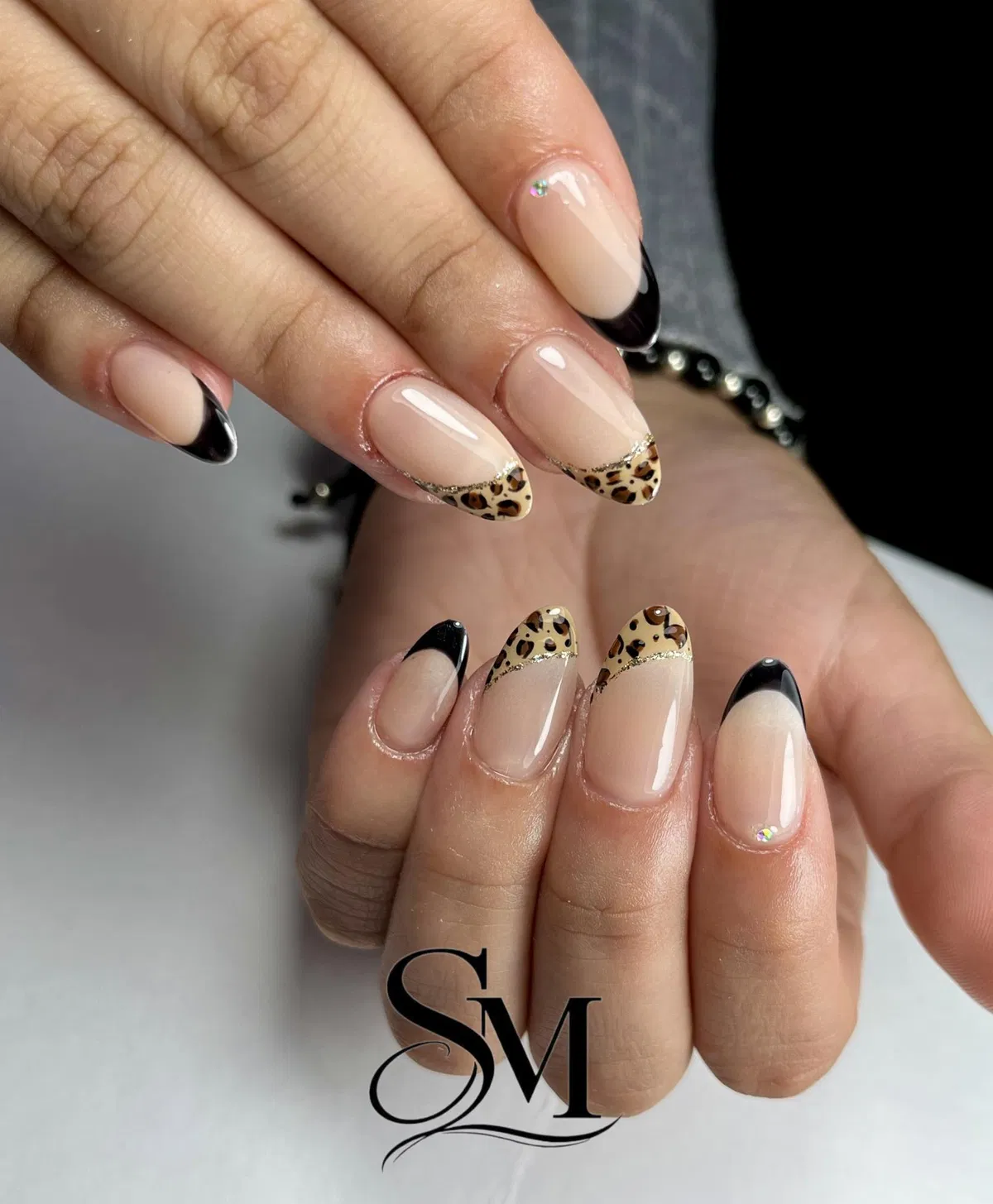 Mixed black tips and leopard-print tips with small rhinestone accents