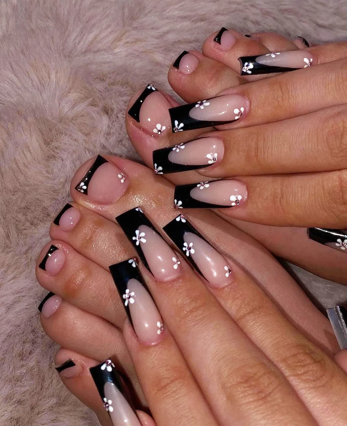 Black French tips with small white flowers (hands and toes)