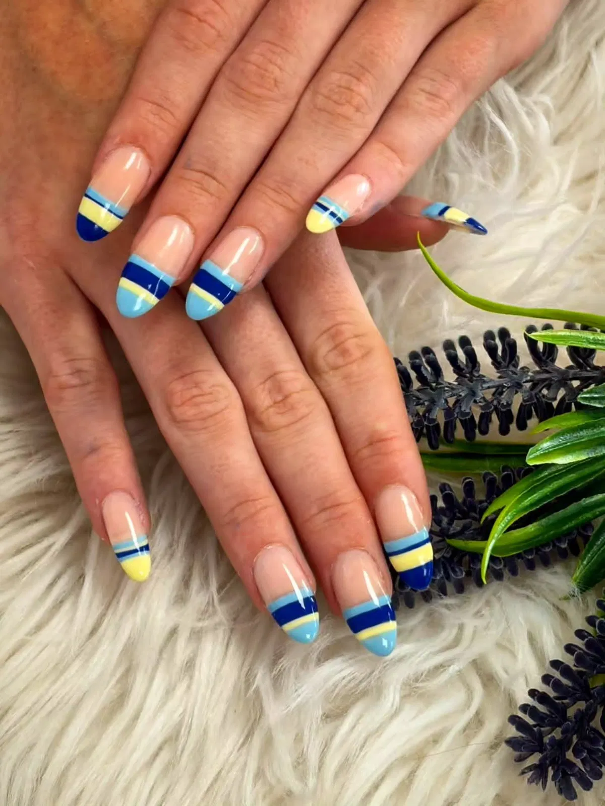 Striped French tips in layered blues and yellow