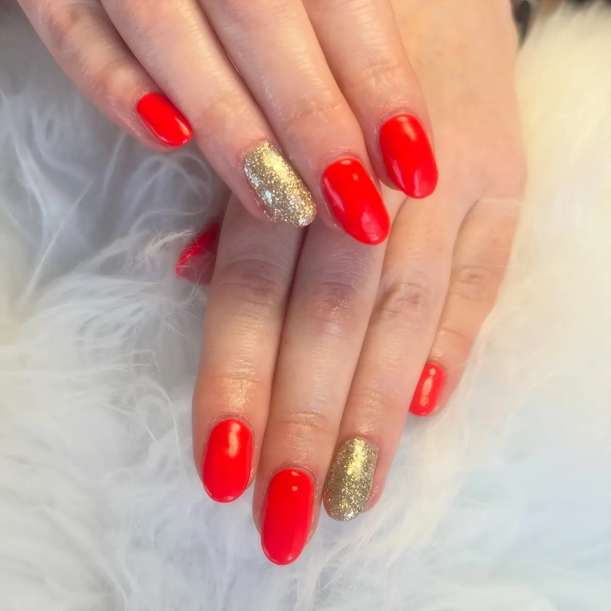 Bright red oval nails with gold accent nails