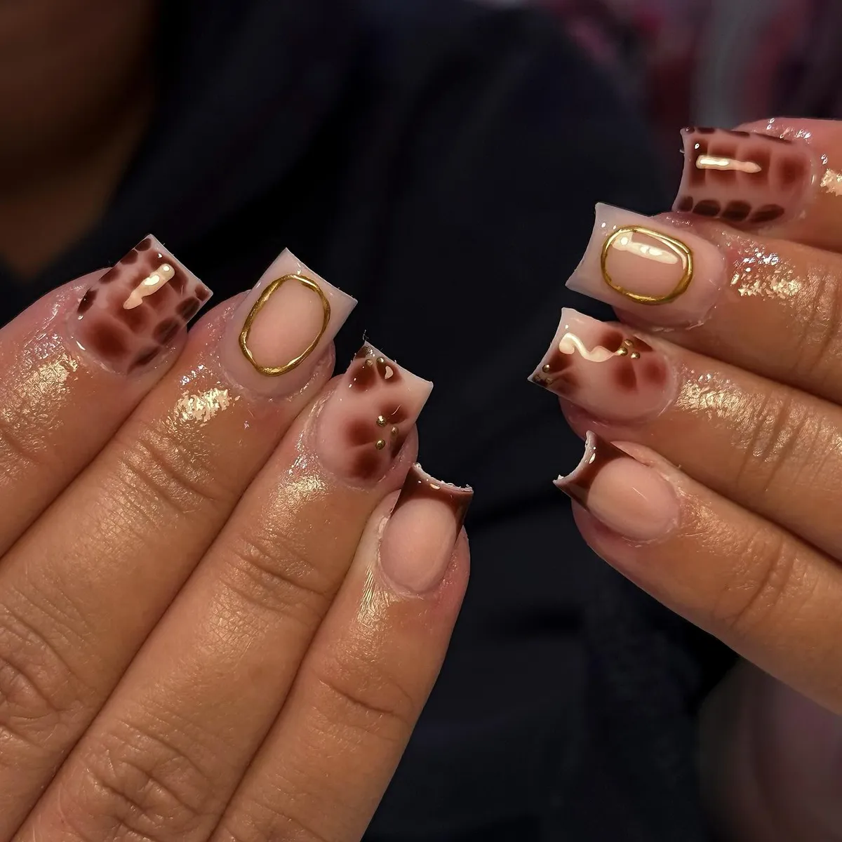 Square nude set with brown spots, gold frame accent, and white waves