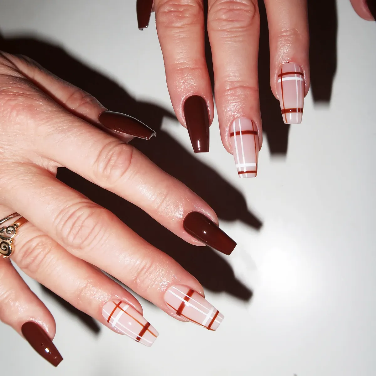 Chocolate brown coffin nails with pale pink and white plaid accents