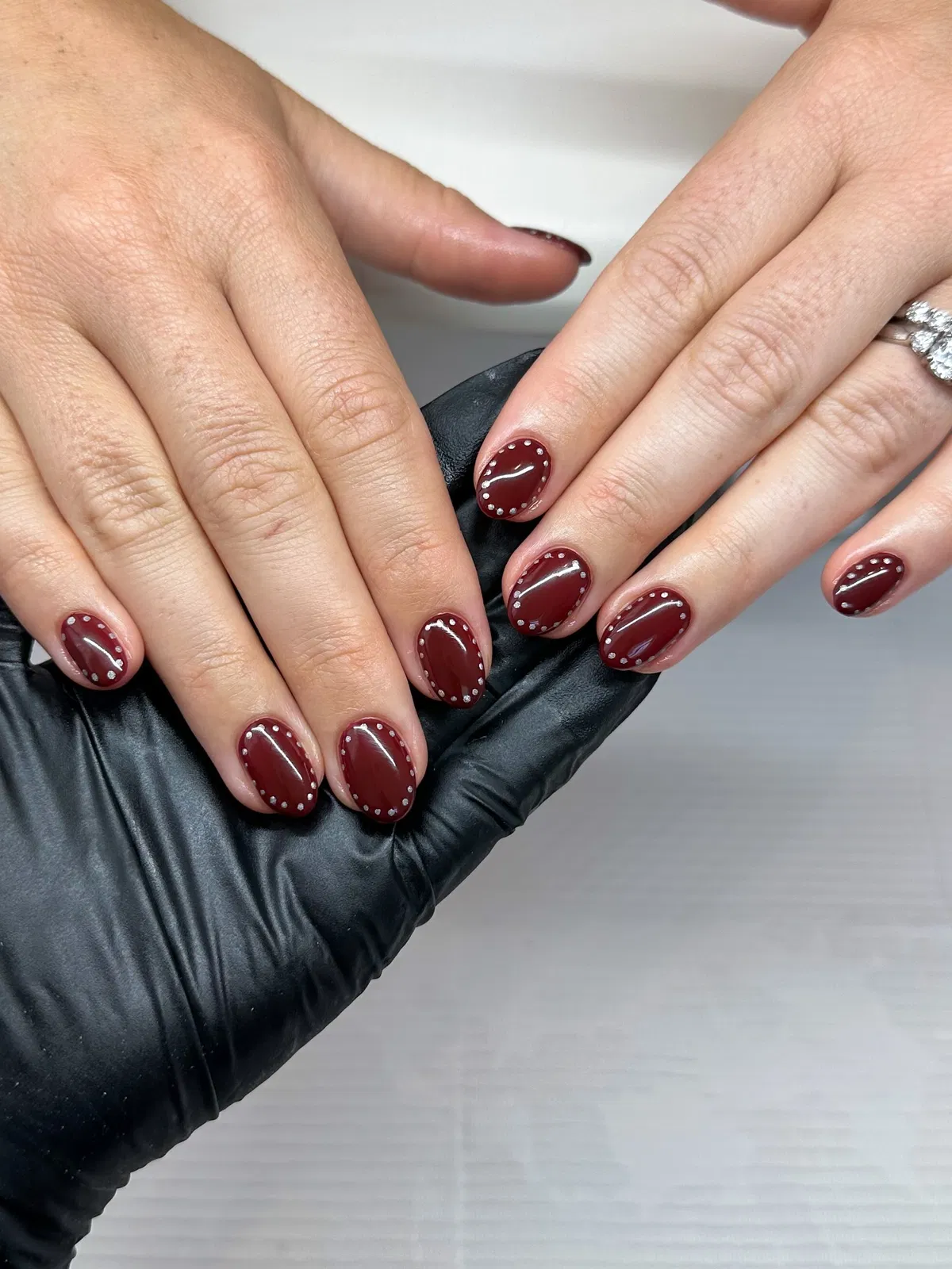 Burgundy nails with dotted edge border