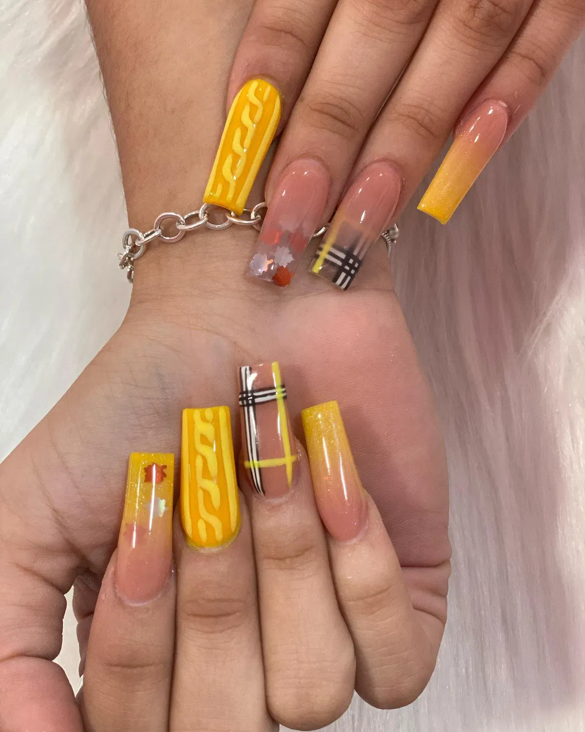 Yellow statement coffin nails with raised waves, plaid lines, and glitter gradients