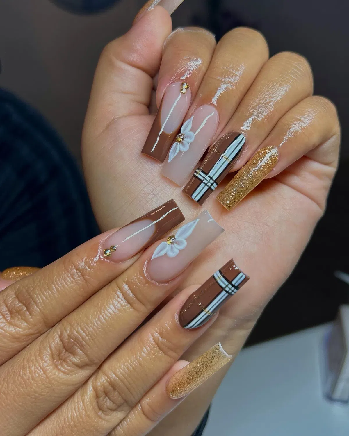 Brown plaid and nude coffin nails with 3D white flowers and a gold glitter accent