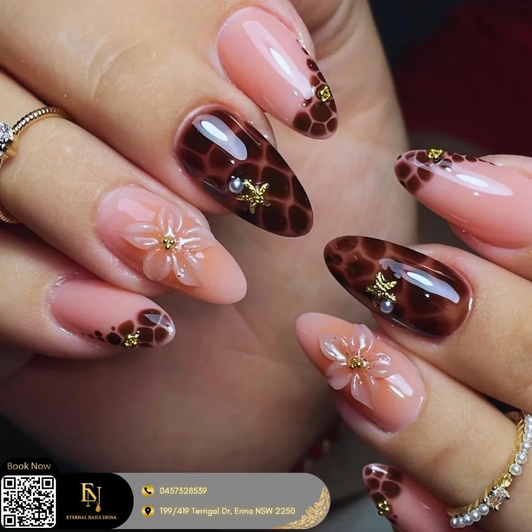 Glossy nude-and-brown tortoiseshell tips with 3D flowers and gold accents
