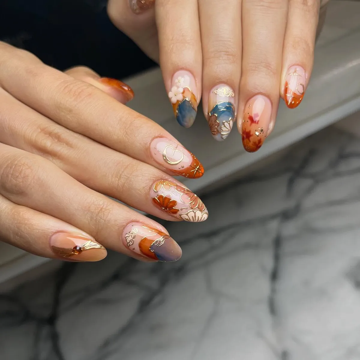 Orange-tipped florals with blue-gray blocks and gold lines