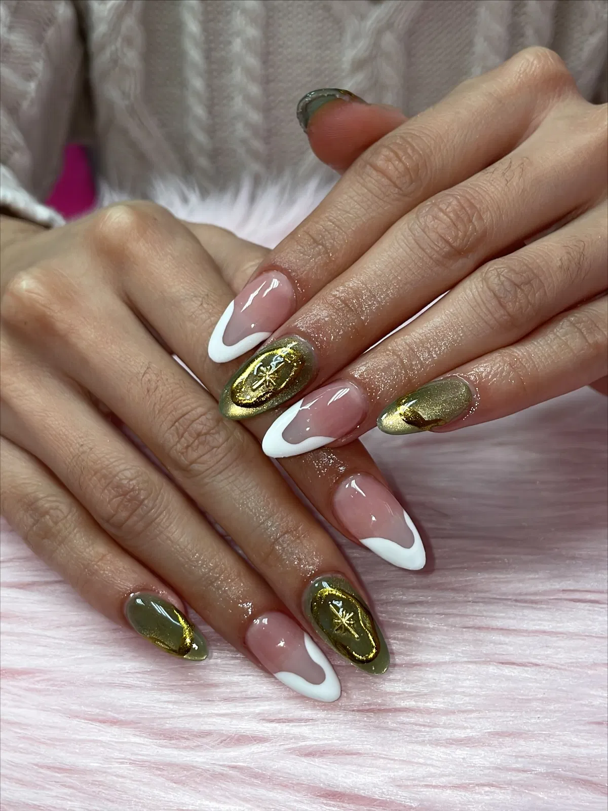White curved French tips with gold and olive accents