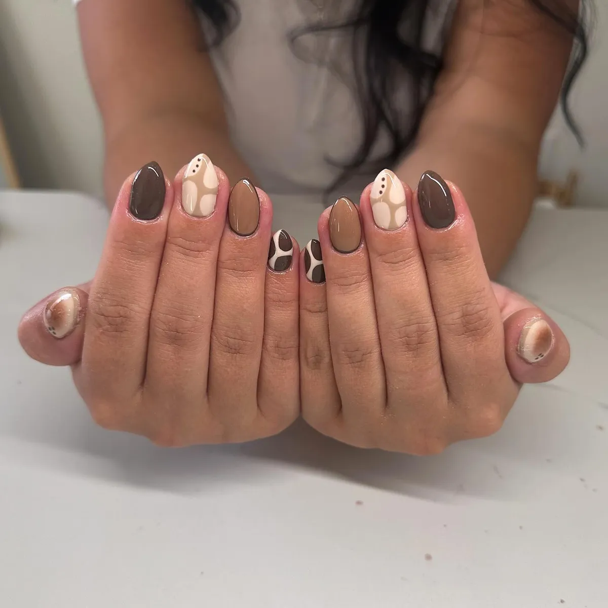 Neutral abstract shapes in brown, beige, and cream