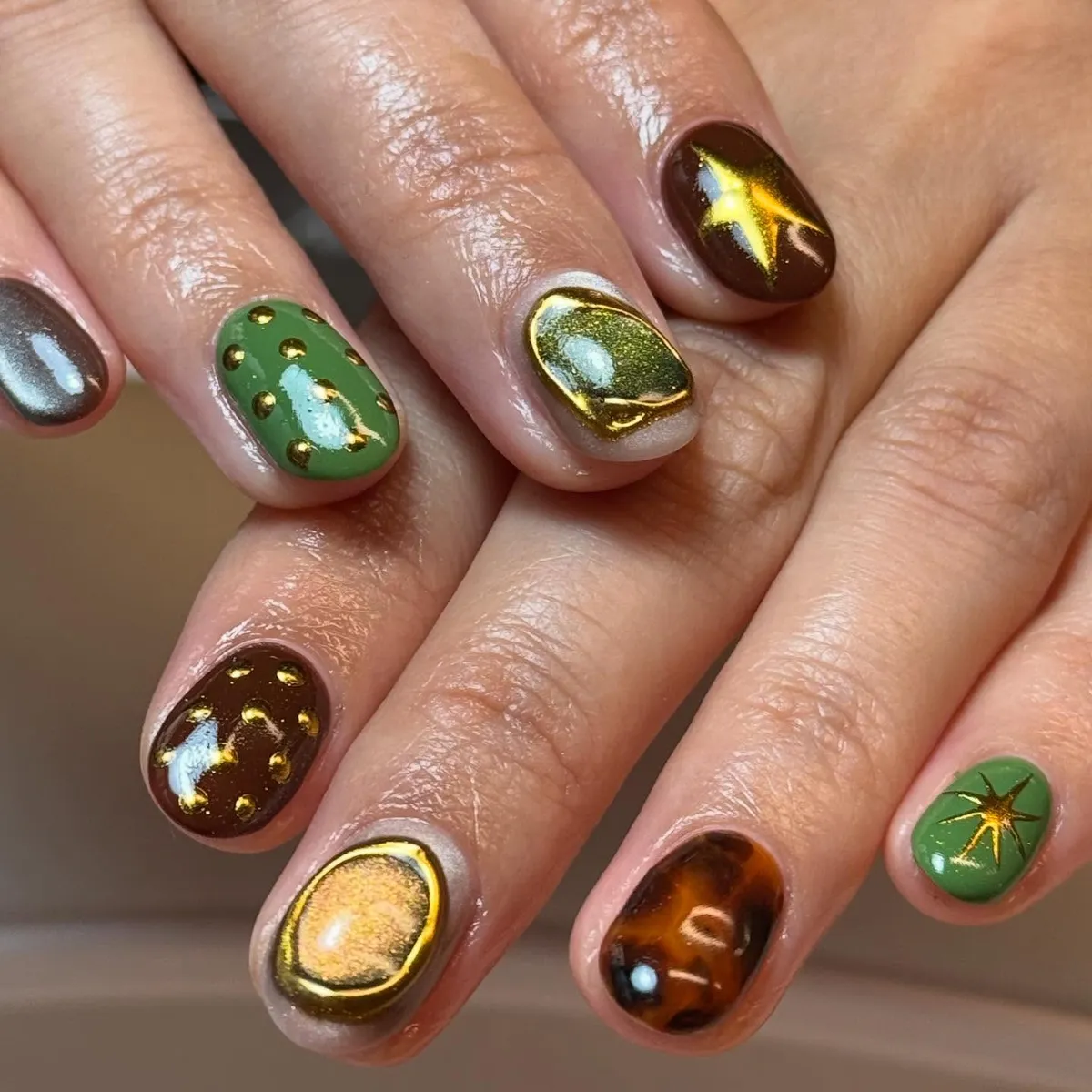 Green and brown mix with gold starbursts and dots