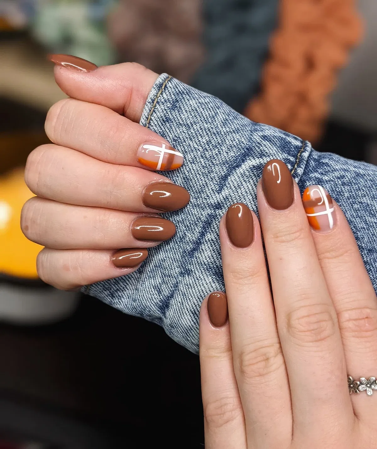 Glossy brown with orange-and-white graphic accents
