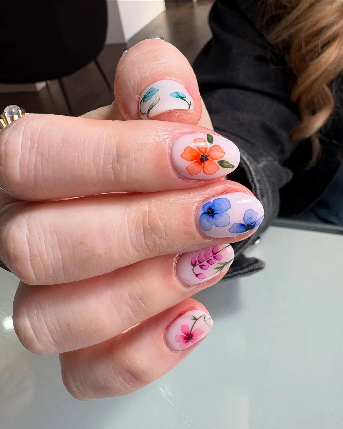 Pale pink base with multicolor floral nail art