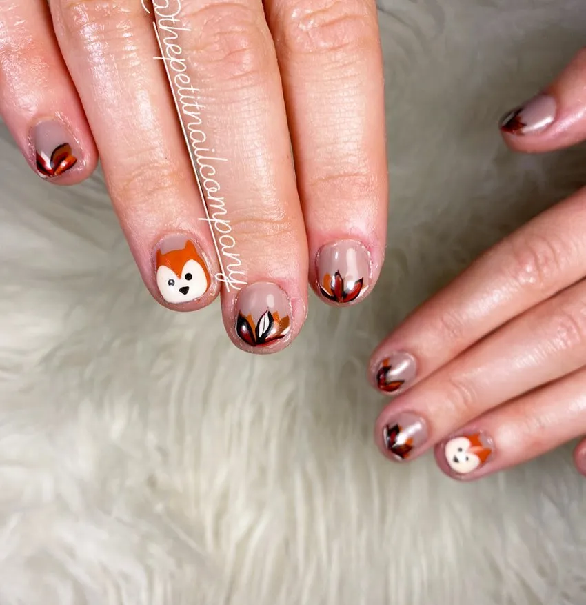 Nude base with orange leaf tips and animal-face accents