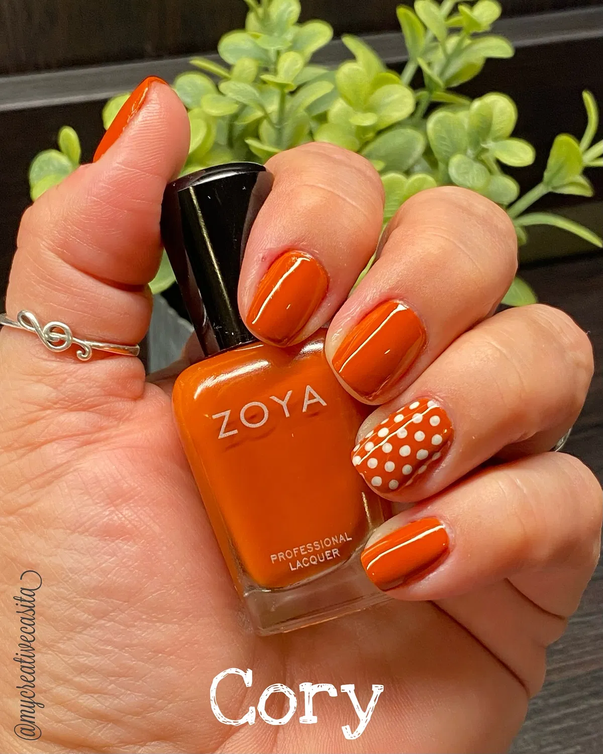 Glossy orange set with white polka-dot accent and visible bottle text