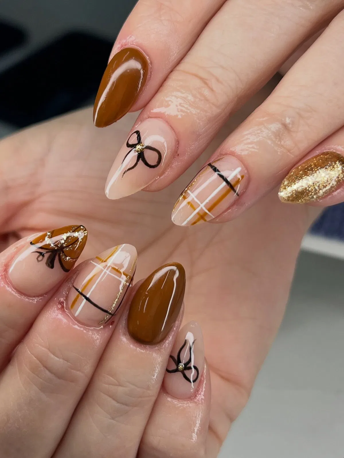 Caramel and nude with bow line art, thin stripes, and gold glitter
