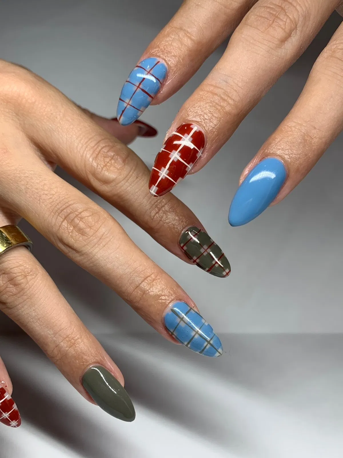 Bold color mix with red-and-white plaid and subtle line grids