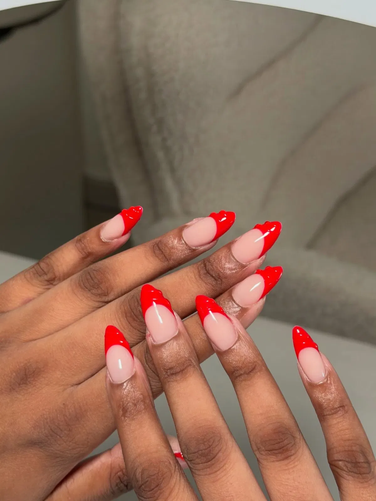 Scalloped red French tips on nude base