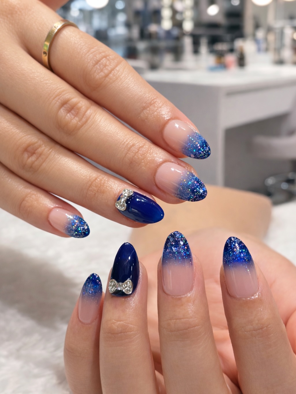 Blue glitter ombré tips with silver bow accents