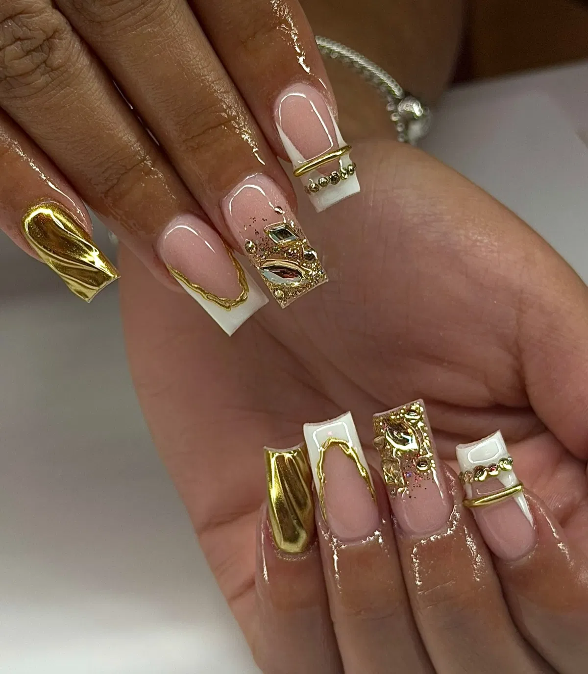 Square nude-and-white set with bold raised gold accents
