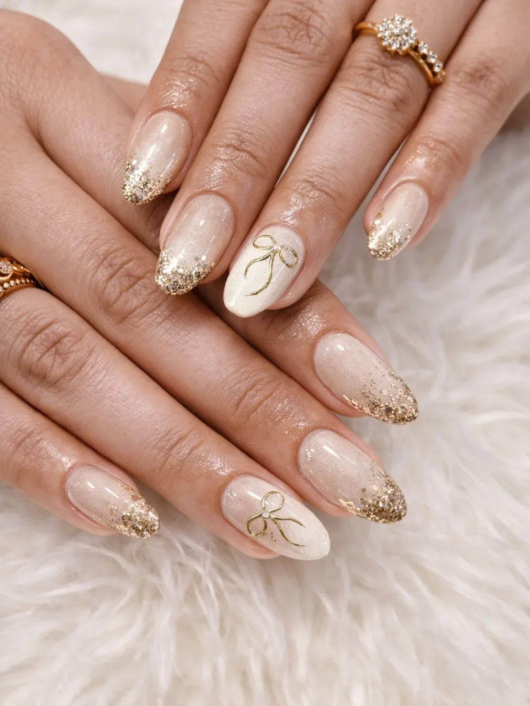 Soft shimmer base with gold tips and bow outlines