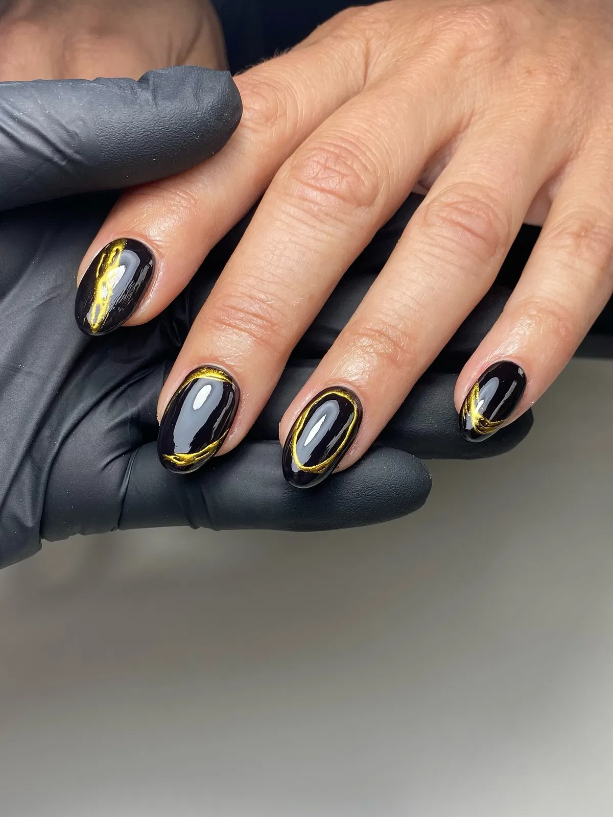 Short glossy black with gold curved outlines and center streak