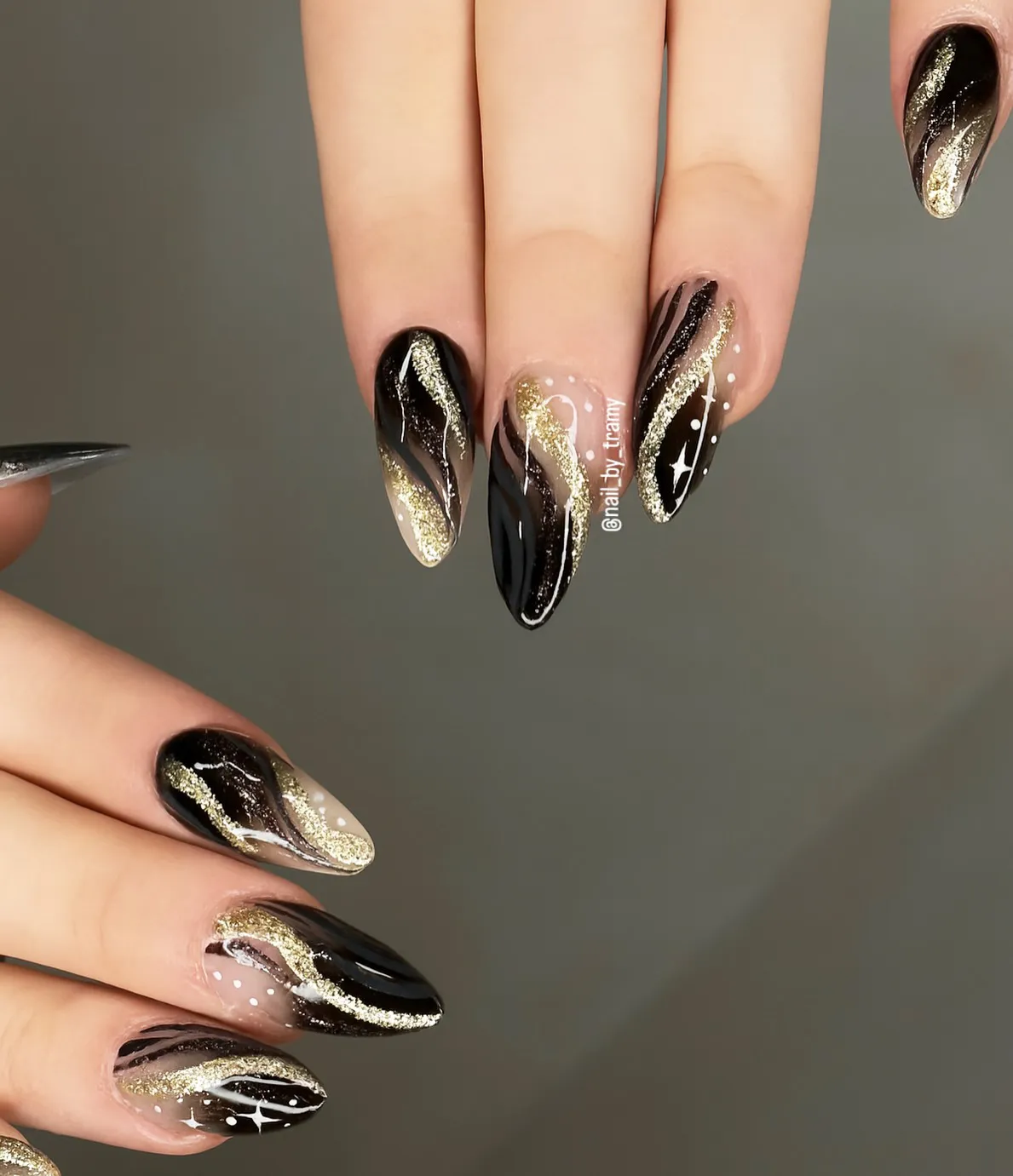 Black-and-gold glitter swirls with white dot accents