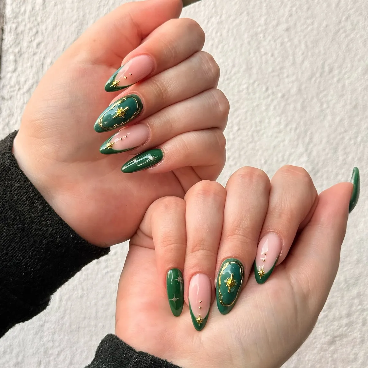 Deep green and nude mix with gold stars and framed green accent nail