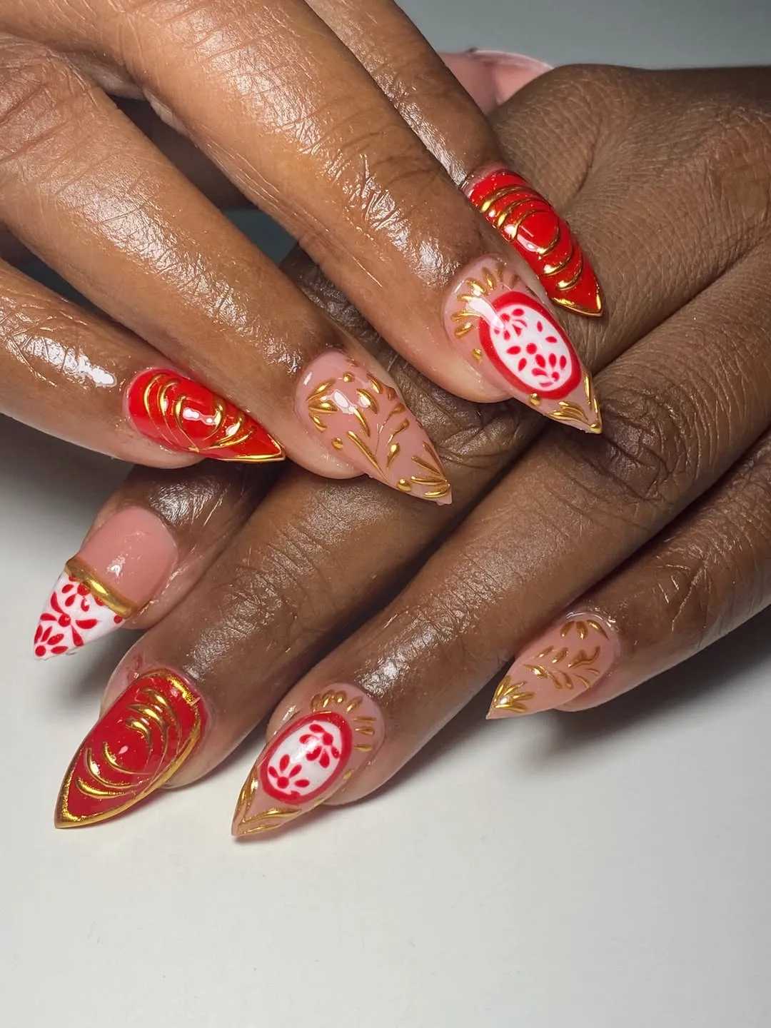 Pointed red-and-nude set with gold swirls and red patterned white accents