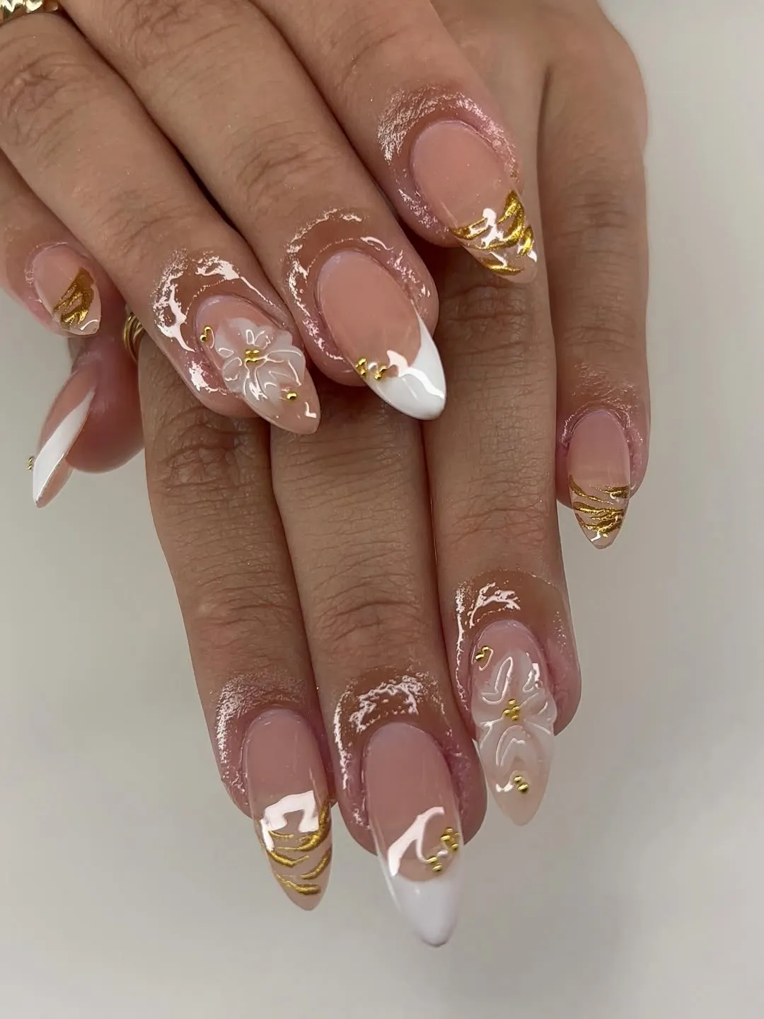 Nude French tips with gold waves and raised white florals