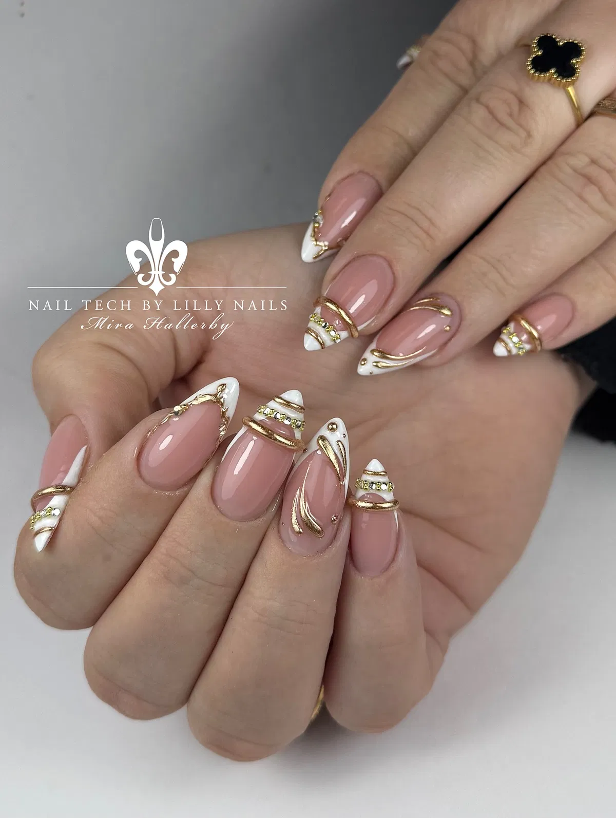 White French tips with gold swirls and rhinestone rows