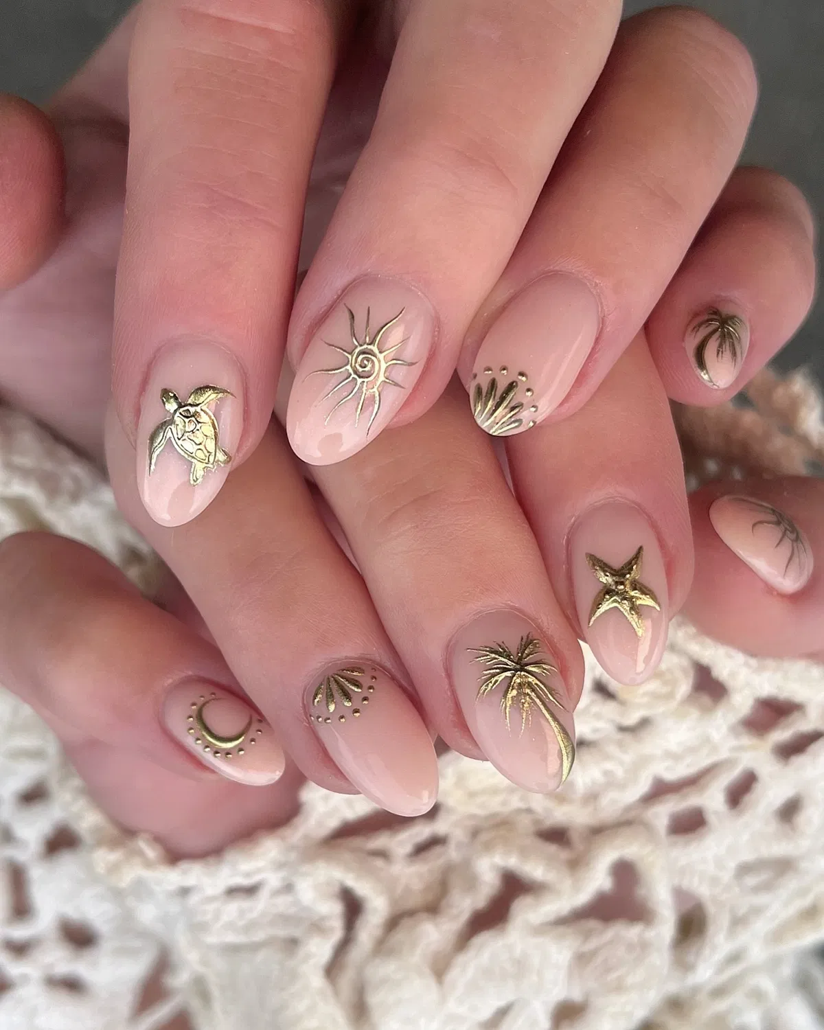 Nude almonds with raised gold beach-themed charms
