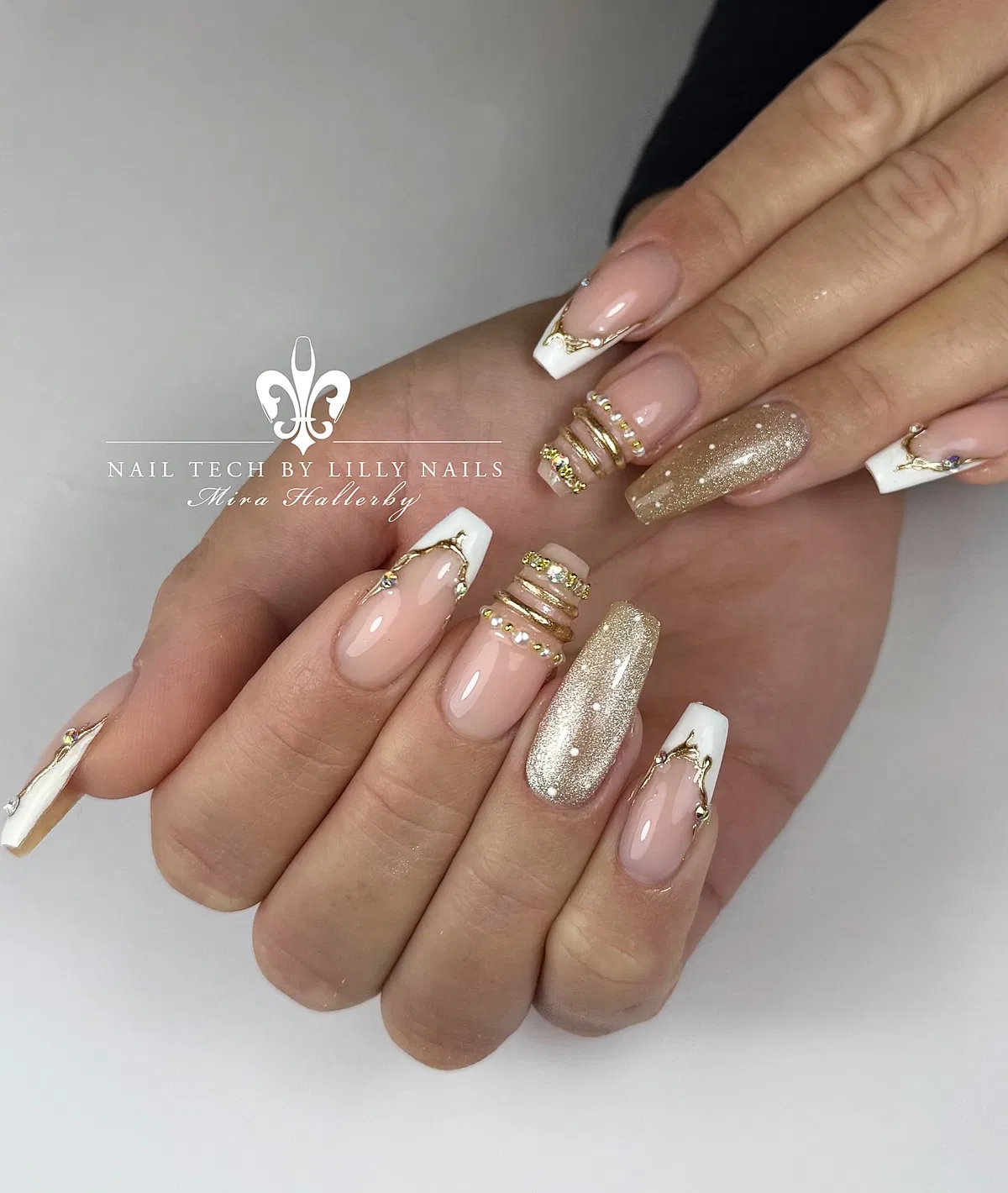 White French tips with gold outline and glitter accents