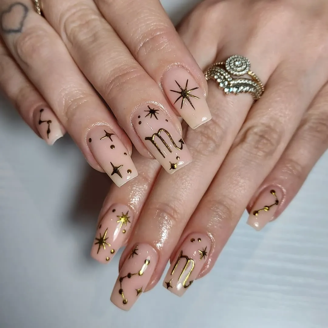 Gold starbursts and squiggles on glossy nude